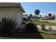 Exterior side view of house showing the garage, driveway, and landscaping at 1727 Boca Raton Ct, Punta Gorda, FL 33950