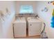 Laundry room with washer, dryer, storage shelf and natural light at 1727 Boca Raton Ct, Punta Gorda, FL 33950