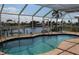 A screened-in pool offers stunning waterfront views in this backyard oasis at 1727 Boca Raton Ct, Punta Gorda, FL 33950