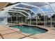 The spacious screened-in pool overlooks lush landscaping and tranquil water views at 1727 Boca Raton Ct, Punta Gorda, FL 33950