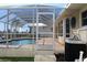 Enclosed pool area with outdoor patio and lush surrounding landscape at 1727 Boca Raton Ct, Punta Gorda, FL 33950