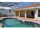 A covered patio sits next to the pool, creating an ideal space for outdoor relaxation at 1727 Boca Raton Ct, Punta Gorda, FL 33950