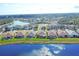 Lakeside community aerial view showing houses along a lake, green lawns, and lush tropical landscaping at 1771 Scarlett Ave, North Port, FL 34289