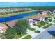 Beautiful aerial view of homes in a lakeside community with lush landscaping, a blue canal and green spaces at 1771 Scarlett Ave, North Port, FL 34289