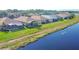 Aerial view of the rear of lakeside homes, showing a community with screened lanais and green lawns at 1771 Scarlett Ave, North Port, FL 34289