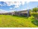 Backyard of homes feature a screened lanai with lake views at 1771 Scarlett Ave, North Port, FL 34289