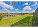 Lush backyard with a peaceful lake view on a sunny day at 1771 Scarlett Ave, North Port, FL 34289