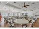 Spacious clubhouse room with ceiling fans, ample seating and an elegant chandelier at 1771 Scarlett Ave, North Port, FL 34289