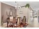 Cozy dining area featuring modern chandelier and stylish décor adjacent to the living area at 1771 Scarlett Ave, North Port, FL 34289