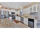 Modern kitchen showcasing stainless steel appliances, granite countertops, and white cabinetry at 1771 Scarlett Ave, North Port, FL 34289