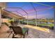 Relaxing screened patio overlooking a tranquil pond, perfect for outdoor living at 1771 Scarlett Ave, North Port, FL 34289