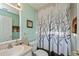 Bathroom featuring a decorative mirror, toilet, sink and decorative shower curtain at 1800 Birmingham Blvd, Punta Gorda, FL 33980