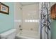 Bathroom featuring a tub with shower, glass block window, and decorative shower curtain at 1800 Birmingham Blvd, Punta Gorda, FL 33980