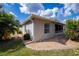 Back of a well maintained one story home with lush, manicured landscaping at 1800 Birmingham Blvd, Punta Gorda, FL 33980