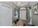 Inviting foyer with tiled flooring, decorative molding, a bench, and a clear view to other parts of the house at 1800 Birmingham Blvd, Punta Gorda, FL 33980