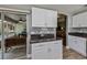 Bright kitchen with white cabinetry, granite countertops, and a view to the screened lanai at 1800 Birmingham Blvd, Punta Gorda, FL 33980