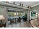 A view from the living room to the screened in porch that includes comfortable furniture and a ceiling fan at 1800 Birmingham Blvd, Punta Gorda, FL 33980