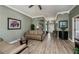 Cozy living room featuring wood-look tile flooring, crown molding, and stylish furnishings at 1800 Birmingham Blvd, Punta Gorda, FL 33980