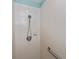 Close up of a shower stall featuring white tiles, grab bar and shower head at 1800 Birmingham Blvd, Punta Gorda, FL 33980