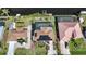 Aerial view of waterfront property highlighting the pool, dock, and solar panels at 18702 Van Nuys Cir, Port Charlotte, FL 33948