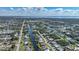 Stunning aerial view of a waterfront neighborhood, with a home circled on a canal, near a bay and a preserved wetland at 18702 Van Nuys Cir, Port Charlotte, FL 33948