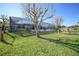 Exterior of a screened-in back porch with a grassy yard and a privacy fence at 18702 Van Nuys Cir, Port Charlotte, FL 33948