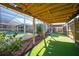 View of covered back patio and synthetic grass backyard at 18702 Van Nuys Cir, Port Charlotte, FL 33948