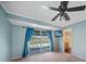 Bedroom with sliding doors leading to the pool and backyard; wall-mounted TV at 18702 Van Nuys Cir, Port Charlotte, FL 33948