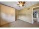 Bedroom with a ceiling fan and an attached closet for ample storage at 18702 Van Nuys Cir, Port Charlotte, FL 33948