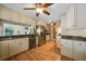 Modern kitchen with stainless steel appliances, wood cabinets, granite countertops and wood floors, with opening to the living room at 18702 Van Nuys Cir, Port Charlotte, FL 33948