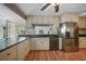 Kitchen featuring stainless steel appliances, granite countertops, hardwood floors and view to backyard through window above sink at 18702 Van Nuys Cir, Port Charlotte, FL 33948