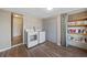 Functional laundry room with modern appliances, shelving, and wood-look floors at 18702 Van Nuys Cir, Port Charlotte, FL 33948