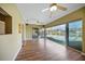 Living room with sliding glass doors that open up to a screened in pool and patio at 18702 Van Nuys Cir, Port Charlotte, FL 33948