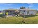 Aerial view of the backyard with patio, shed, and green lawn at 188 Cypress Nw Ave, Port Charlotte, FL 33952