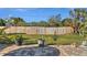 Spacious backyard with green lawn, wood fence, and decorative plants at 188 Cypress Nw Ave, Port Charlotte, FL 33952