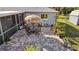 Aerial view of the backyard with stone paver patio, table, umbrella, and grill at 188 Cypress Nw Ave, Port Charlotte, FL 33952