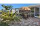 Backyard patio area featuring a glass table and seating in a well landscaped backyard at 188 Cypress Nw Ave, Port Charlotte, FL 33952