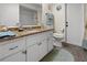 Bathroom featuring a vanity with granite countertops, a sink, and a toilet for comfort and convenience at 188 Cypress Nw Ave, Port Charlotte, FL 33952