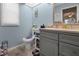 Bright bathroom with gray vanity, neutral countertop, and cute toilet seat decor at 188 Cypress Nw Ave, Port Charlotte, FL 33952