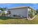 Side view of the home featuring gravel landscaping and decorative planters at 188 Cypress Nw Ave, Port Charlotte, FL 33952