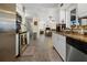 Kitchen with white cabinets, stainless steel appliances, and an open view to the dining room at 188 Cypress Nw Ave, Port Charlotte, FL 33952