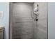 The remodeled shower is tiled with gray and has a brushed nickel shower head at 188 Cypress Nw Ave, Port Charlotte, FL 33952