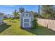 Charming backyard shed with a decorative door and a small garden at 188 Cypress Nw Ave, Port Charlotte, FL 33952