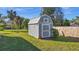 Backyard shed with grass and plantings at 188 Cypress Nw Ave, Port Charlotte, FL 33952