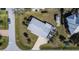 Bird's eye view of a single-Gathering home with a sunroom, carport, and backyard shed at 21192 Knollwood Ave, Port Charlotte, FL 33952