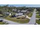 Aerial view of a single-story home with landscaped yard, carport, and a storage shed at 21192 Knollwood Ave, Port Charlotte, FL 33952