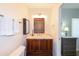 Bathroom with a wooden vanity, tiled floors, and recessed lighting at 21192 Knollwood Ave, Port Charlotte, FL 33952