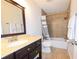 Bathroom with a vanity, sink, mirror, toilet, and tiled shower at 21192 Knollwood Ave, Port Charlotte, FL 33952