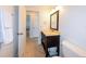 Bathroom featuring a dark wood vanity with mirror and tiled floors at 21192 Knollwood Ave, Port Charlotte, FL 33952