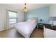 Bedroom with neutral decor, light blue accent wall, and stylish chandelier at 21192 Knollwood Ave, Port Charlotte, FL 33952